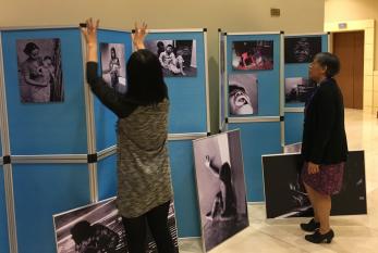 Rochelle Diver and Yuyun Ismawati setting up photo exhibit