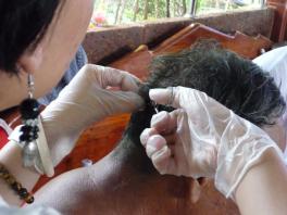 Taking hair samples for mercury testing in Thailand